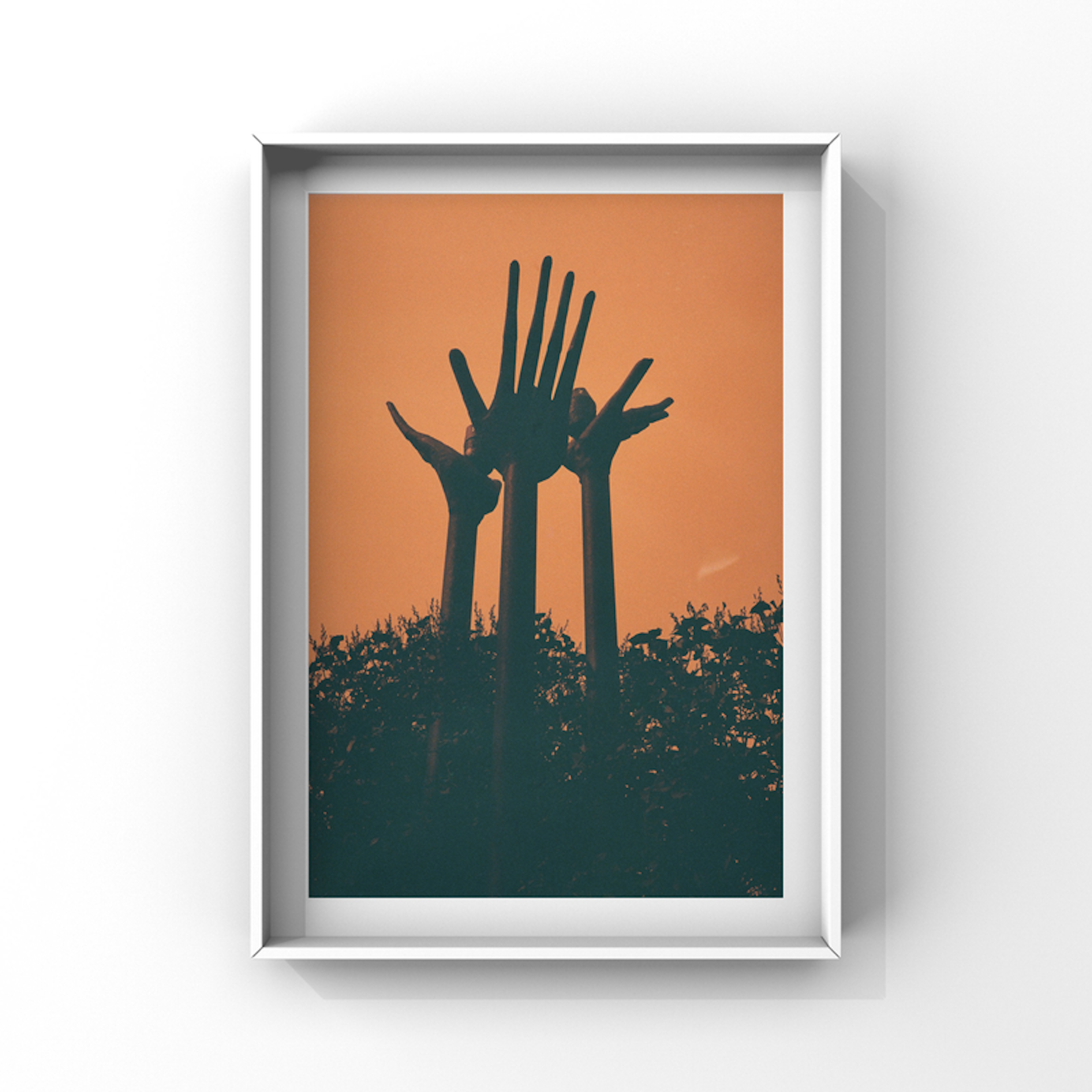 Hands towards an orange sky